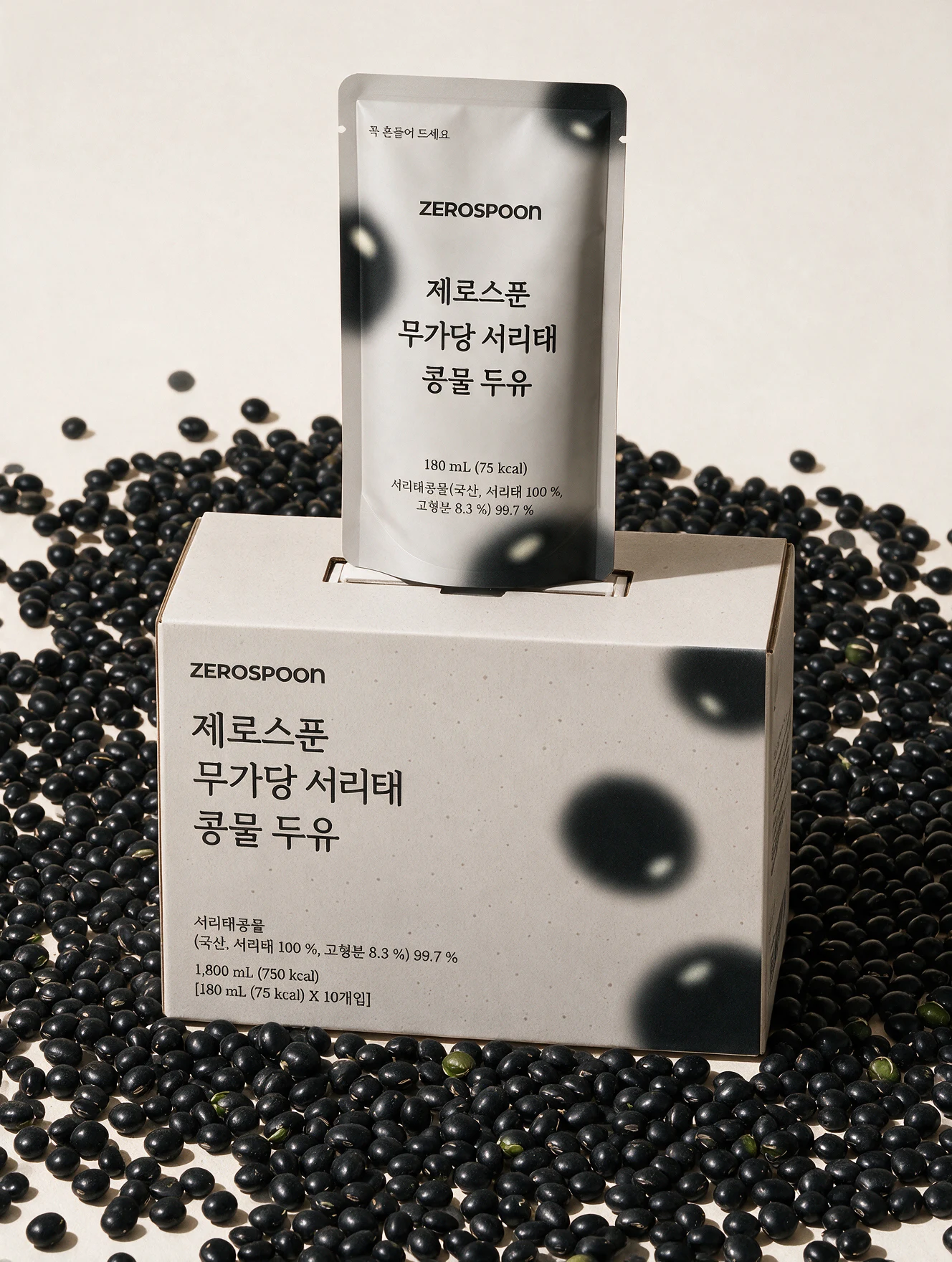 Soy milk pouch and box surrounded by black soybeans